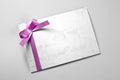 Blank thank you card decorated with violet ribbon