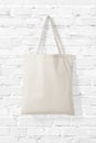 Blank Tote Canvas Bag Mockup on white brick wall background.