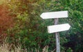 Blank track pointers or guidepost against green nature background. Royalty Free Stock Photo