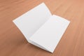 Blank tri fold brochure on wooden background Royalty Free Stock Photo