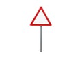 Blank triangular warning sign on a pole against a black background Royalty Free Stock Photo