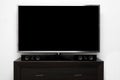 Blank tv with stereo system on brown commode Royalty Free Stock Photo