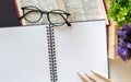 Blank two sketchbooks with three sharpen pencils, an eye-glasses and decoration plant on white background in flat lay concept