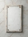 Blank vertical memorial plaque weathered white surface. Old rectangular frame with four studs attaches to textured, cracked stone Royalty Free Stock Photo