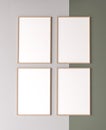 Blank vertical poster frame mock up on beige and green background. Four wooden wooden frames