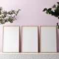 Blank vertical poster frame mock up standing on beige floor. Three wooden frames isolated in Scandinavian interior. 3d render Royalty Free Stock Photo