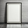 Blank vertical poster frame standing on a wooden floor against a white brick wall, mock-up for design presentation Royalty Free Stock Photo