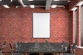 Blank vertical poster mock up on the red brick wall in office interior. Royalty Free Stock Photo