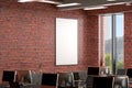 Blank vertical poster mock up on the red brick wall in office interior. Royalty Free Stock Photo