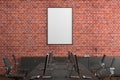 Blank vertical poster mock up on the red brick wall in office interior. Royalty Free Stock Photo