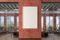 Blank vertical poster mock up on the red brick wall in office interior. Royalty Free Stock Photo