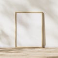 Blank vertical wooden frame mock up, wooden poster frame on wooden floor with sunlight with leaves shadow on white wall, 3d