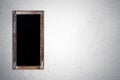 Blank vintage chalk board on grunge cement wall