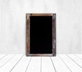 Blank vintage chalk board on white cement wall