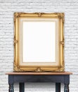Blank vintage golden photo frame lean at white brick wall on woo Royalty Free Stock Photo