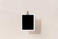 Blank Vintage instant photo frame hanging on a rope Royalty Free Stock Photo