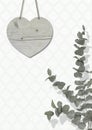 Blank weathered wooden heart on wall with moroccan print wallpaper, with Eucalyptus cinerea, interior still life