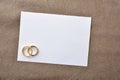 Blank wedding card with rings background on brown cloth Royalty Free Stock Photo