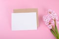 Blank wedding invitation stationery card mockup with envelope on pink background with hyacinth flowers Royalty Free Stock Photo