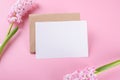 Blank wedding invitation stationery card mockup with envelope on pink background with hyacinth flowers Royalty Free Stock Photo