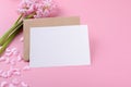 Blank wedding invitation stationery card mockup with envelope on pink background with hyacinth flowers and pink heart Royalty Free Stock Photo