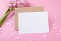 Blank wedding invitation stationery card mockup with envelope on pink background with hyacinth flowers and pink heart Royalty Free Stock Photo