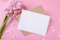 Blank wedding invitation stationery card mockup with envelope on pink background with hyacinth flowers and pink heart Royalty Free Stock Photo