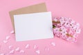 Blank wedding invitation stationery card mockup with envelope on pink background with hyacinth flowers and pink heart Royalty Free Stock Photo