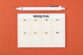 The Blank weekly plan notice block on orange colour background. Empty schedule and a pen