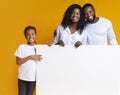 Blank white advertisement board in hands of happy black family Royalty Free Stock Photo