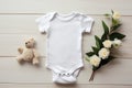 Blank White Baby Grow on a Cream Textile Background with Green Leaves - Floral Baby Bodysuit Mockup Styled Generative AI