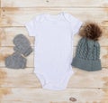 Blank white babygrow winter mock up on white washed wood background