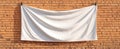 The blank white banner hanging against a rustic brick wall backdrop. AI generated image Royalty Free Stock Photo
