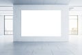 Blank white big poster on grey wall in empty spacious hall with big windows and city view. Mockup Royalty Free Stock Photo