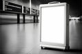 Blank white billboard in airport terminal, ready for your design. Royalty Free Stock Photo