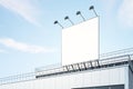 Blank white billboard outdoor with backlights from top on modern industrial building roof at blue sky background. 3D rendering, Royalty Free Stock Photo
