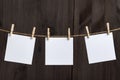 Blank white blank square note paper cards hang with clothespins on rope. Place for your text. Copy space Royalty Free Stock Photo