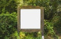 A blank white board in a forest for information ,sign for advert Royalty Free Stock Photo