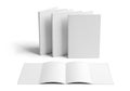 Blank white book covers arranged in a stack and an open book on a white background Royalty Free Stock Photo