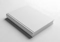 A blank white book lies on a plain surface casting a subtle shadow Royalty Free Stock Photo