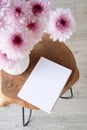 blank white book for mockup design, composition of pink Scandinavian vase with purple daisies, interior decoration Royalty Free Stock Photo