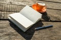 Blank white book with pencil and coffee cup over old weathered w Royalty Free Stock Photo