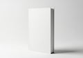 Blank white book standing upright on a light gray surface Royalty Free Stock Photo