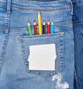 blank white business card and colored pencils in the back pocket of blue jeans Royalty Free Stock Photo