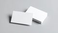 Blank White Business Card Floating in Front of a Stack on Gray Surface paper Royalty Free Stock Photo