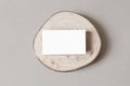 Blank white business card mockup on wooden plate, chop board. Grey table backgound. Modern minimalist template. Branding