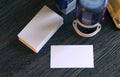 Blank white business cards lying on wooden office table with office supply as template for design presentation, brand promotion, Royalty Free Stock Photo