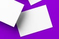 Blank white businesscards on purple background, copy space