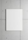 A blank white canvas mounted on a light gray concrete wall with visible joints and Royalty Free Stock Photo
