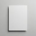 A blank white canvas or sheet of paper is centered against a light gray background. The surface Royalty Free Stock Photo